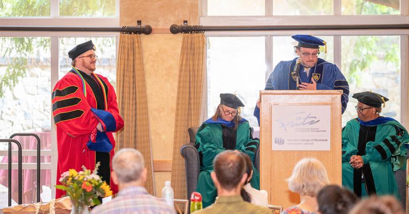 Brendon Holloway PhD Hooding Ceremony and Eugene Walls on the stand