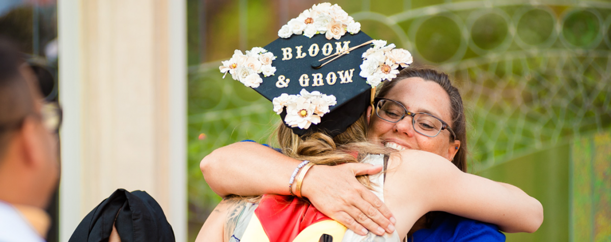 msw graduate with bloom and grow graduation cap