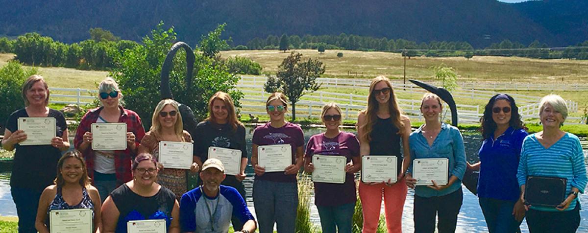 AHH Graduates with Certificates in front of the Rockies