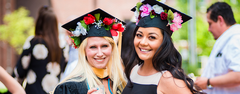 two female msw students on graduation day