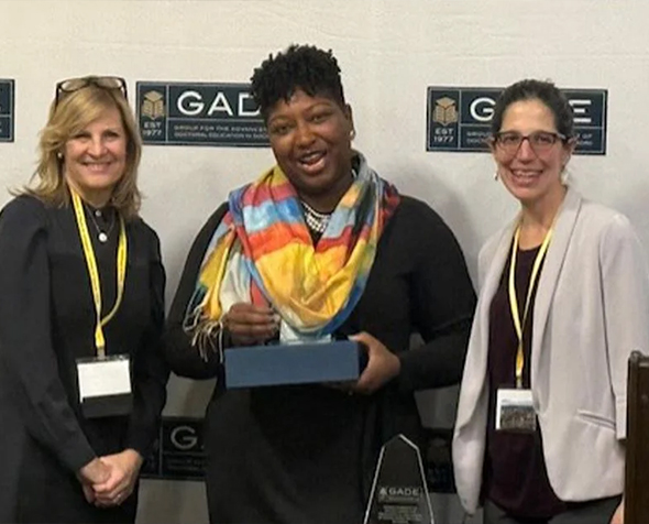 GSSW Assistant Professor Marquisha Lawrence Scott (center) receives an early career achievement award