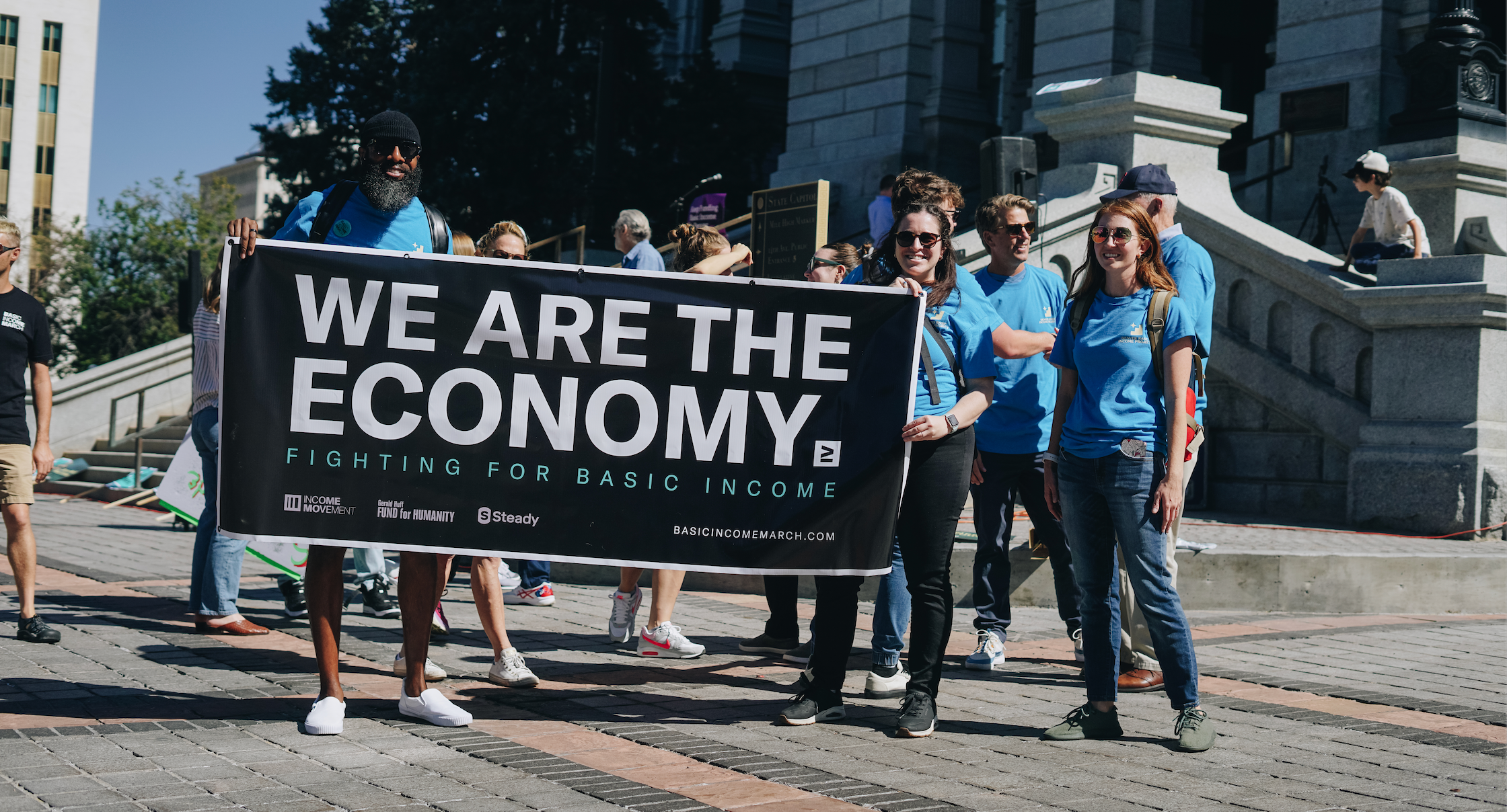 marchers holding a sign reading "we are the economy"