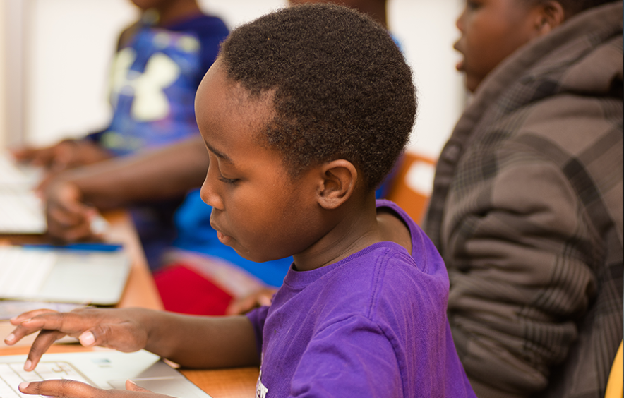 young black child on computer