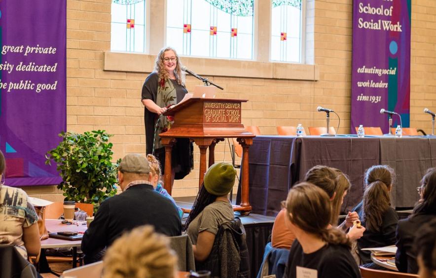 woman at podium speaking to audience