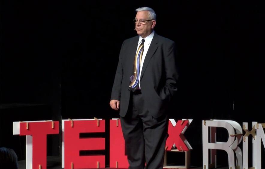 Donald Burnes standing on TED Talk stage