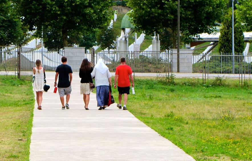 group walking towards cemetery