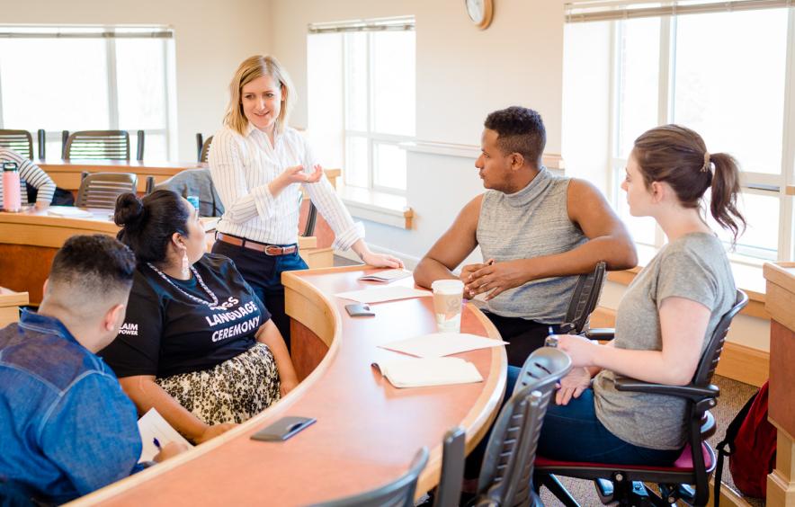 teacher speaking to students in small group