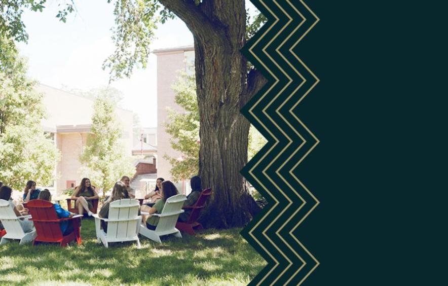 Students holding class under a tree at Denver Campus