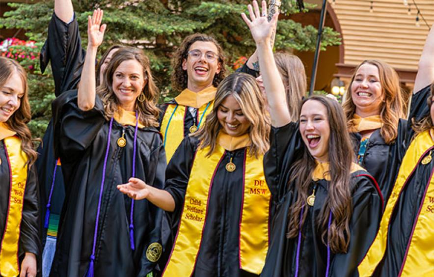 Students in regalia cheering