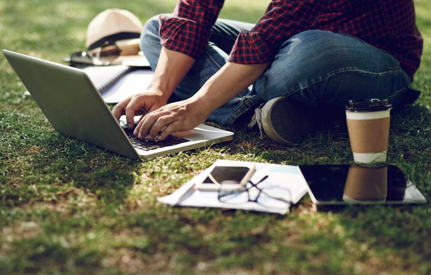 man on computer outside