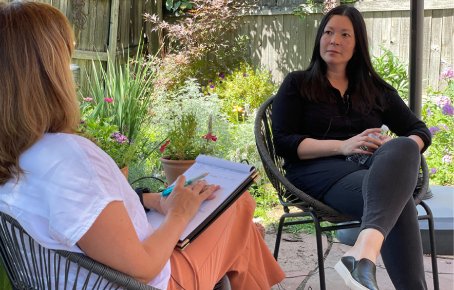 Woman with clipboard talking to woman about coaching