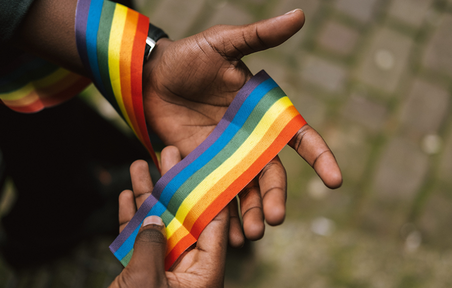 person hands rainbow ribbon