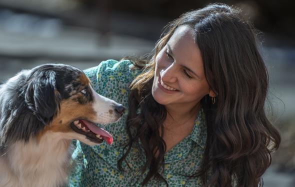 Woman with dog, Australian Shepherd, exhibiting animal-assisted therapy