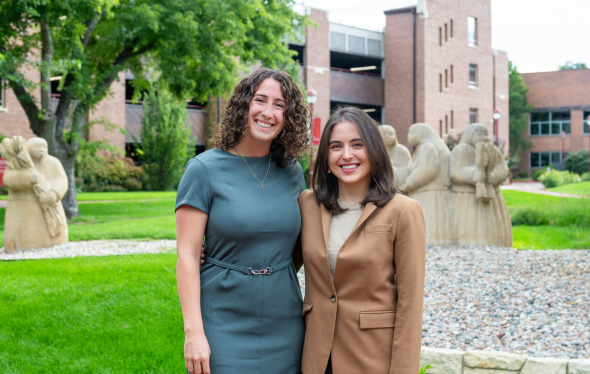 Equity researchers Liana and Kaleigh stand outside side-by-side