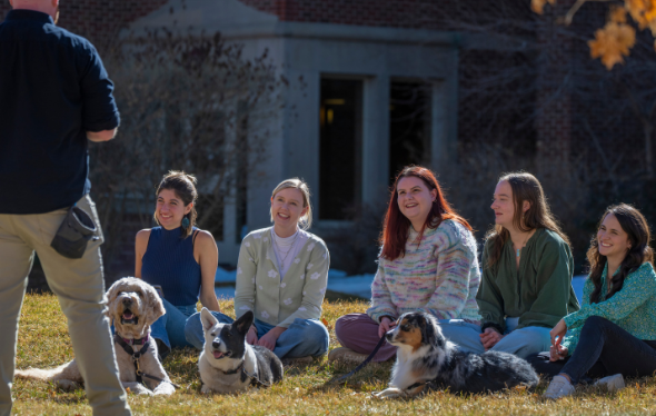 man teaching students with dogs