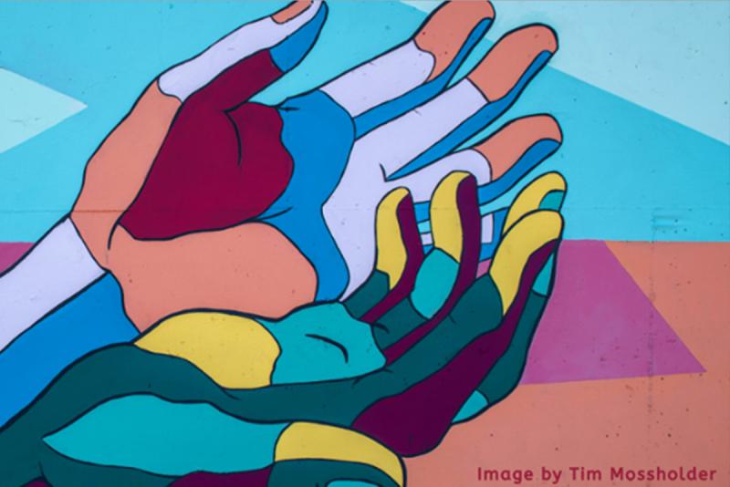 Wall mural featuring multi colored hands