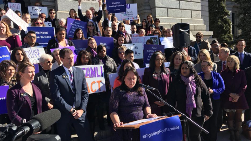 group of people speaking at rally