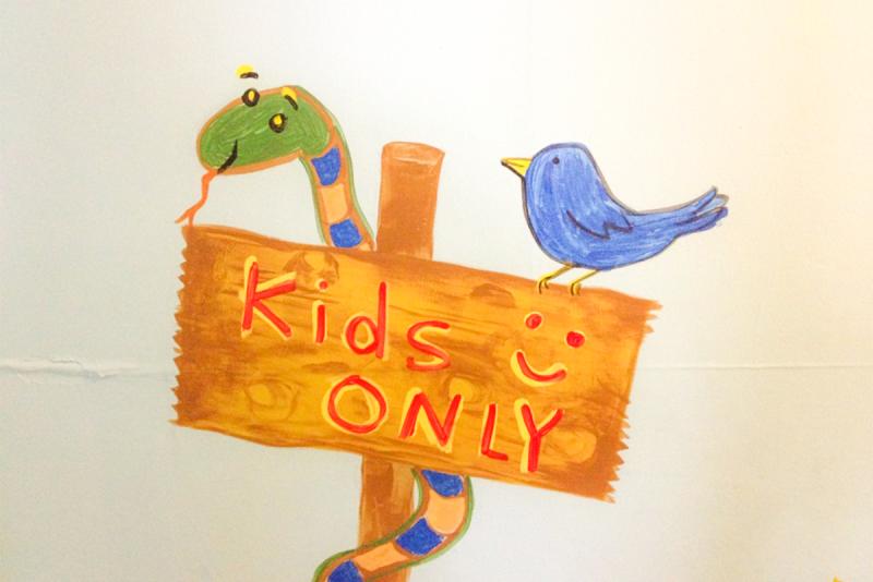Featured Media Image of a painted sign reading "kids only" with a friendly snake and bird
