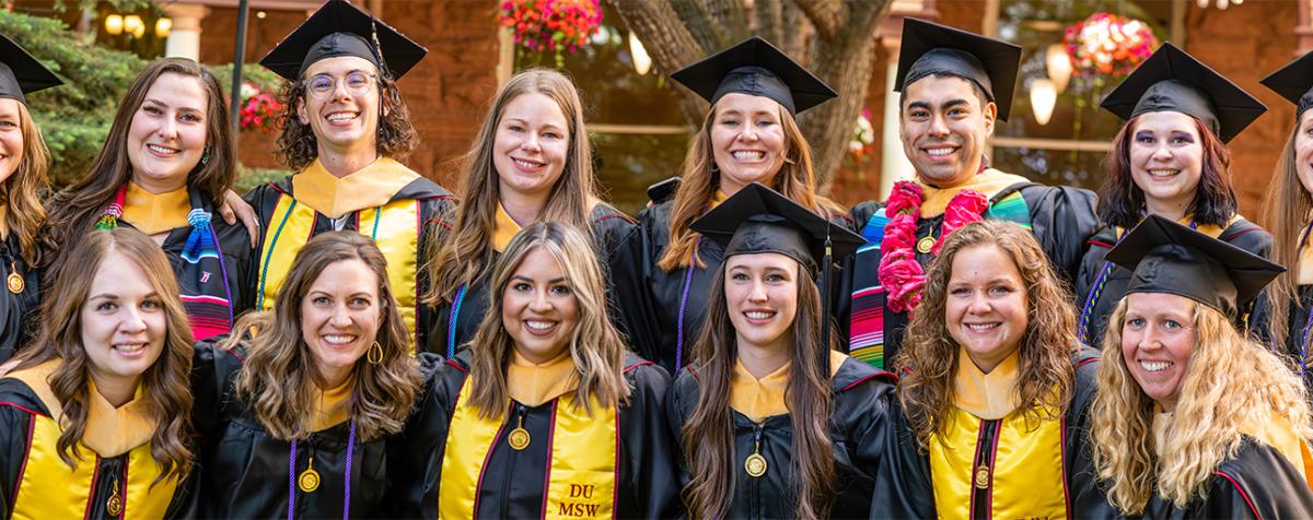 group of graduates posing for a photo