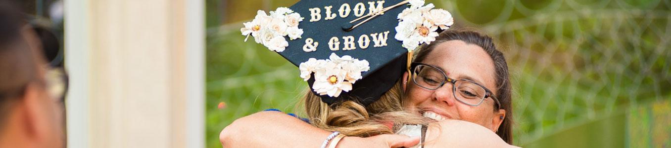 msw graduate with bloom and grow graduation cap