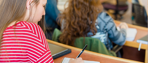 student writing in class