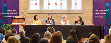 people on panel speaking to audience