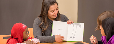 pre-school teacher reading to students